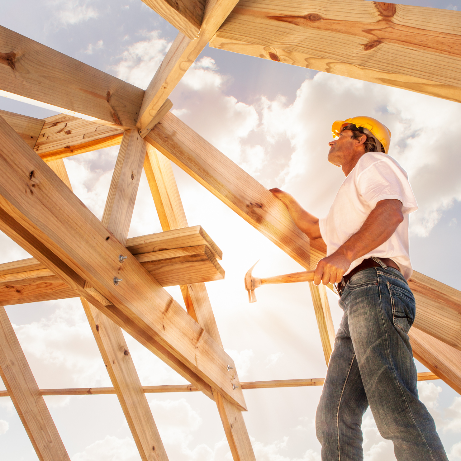 worker building a wooden home frame